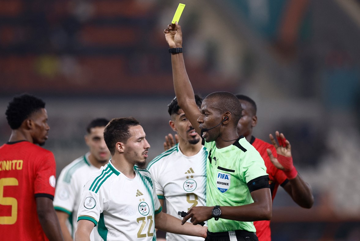 Algeria held by Angola in Africa Cup of Nations opener - Referee Sy Issa shows a yellow card to Algeria's midfielder #19 Nabil Bentaleb (unseen) during the Africa Cup of Nations 2023 group D football match between Algeria and Angola at Stade de la Paix in Bouake on January 15, 2024. (Photo by KENZO TRIBOUILLARD / AFP)