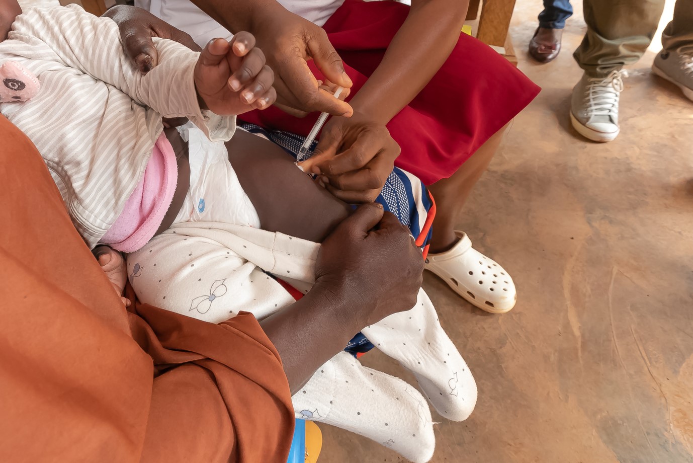 New study to examine link between childhood vaccines and autism risk - A health worker administers a malaria vaccine to a baby at a hospital. New study to examine link between childhood vaccines and autism risk. (Photo: Etienne Nsom/ AFP)