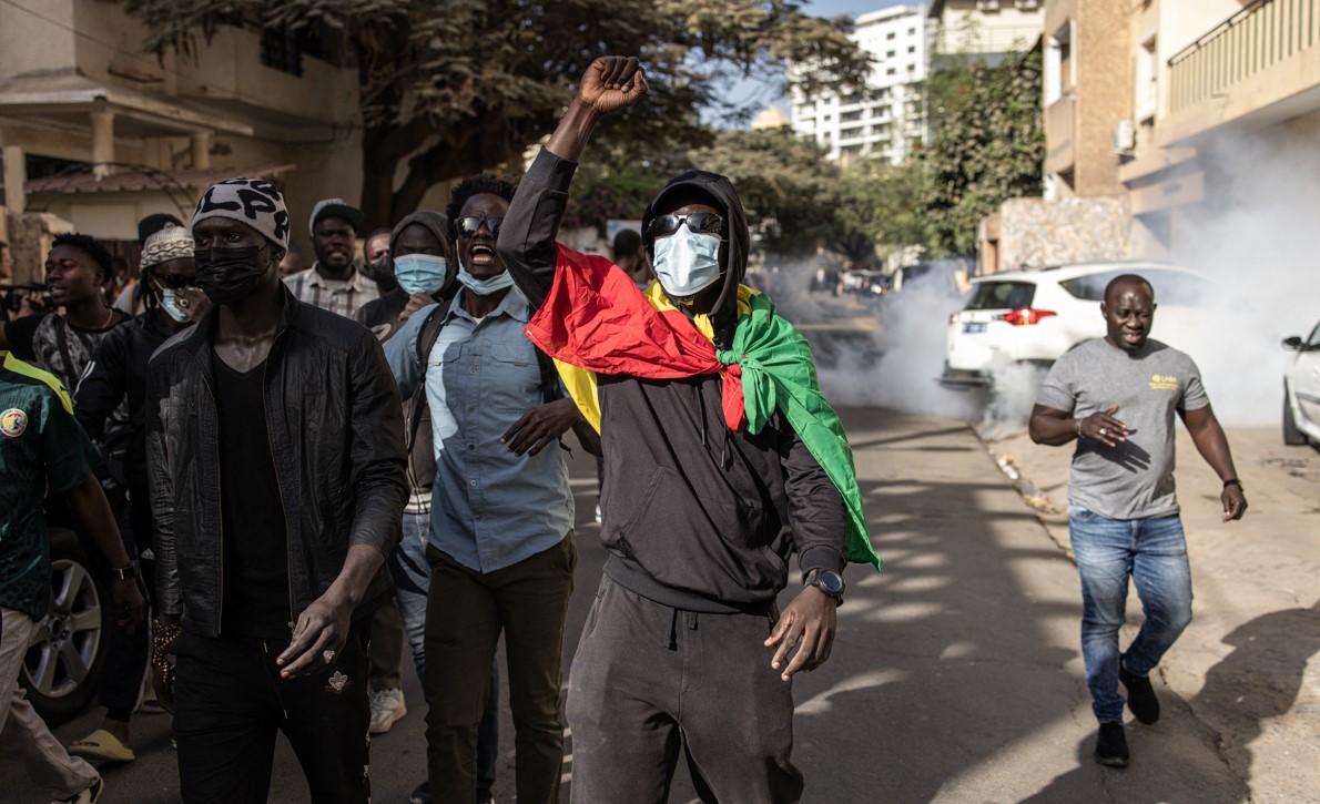 Clashes as Senegal parliament delays presidential poll - Protesters gesture after police fired teargas at them outside the General Assembly in Plateau, Dakar on February 5, 2024. (Photo: John Wessels/AFP)