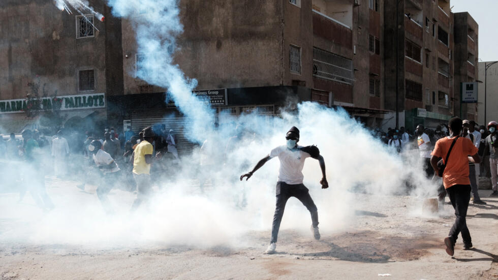 Senegal protest march over election delay postponed - A protester throws back a tear gas canister during clashes with police on the sidelines of a protest against a last-minute delay of the Senegalese presidential elections in Dakar, Senegal, on February 9, 2024. (Photo: Guy Peterson/ AFP)