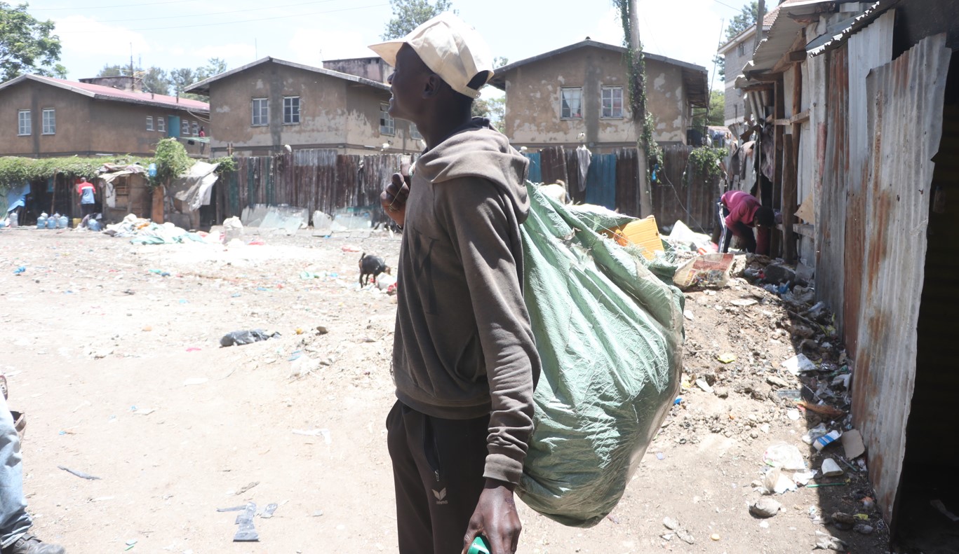 A Majengo, Pumwani resident pictured with a gunny bag of garbage and other disposable items in March 2024. (Photo: Justine Ondieki) 