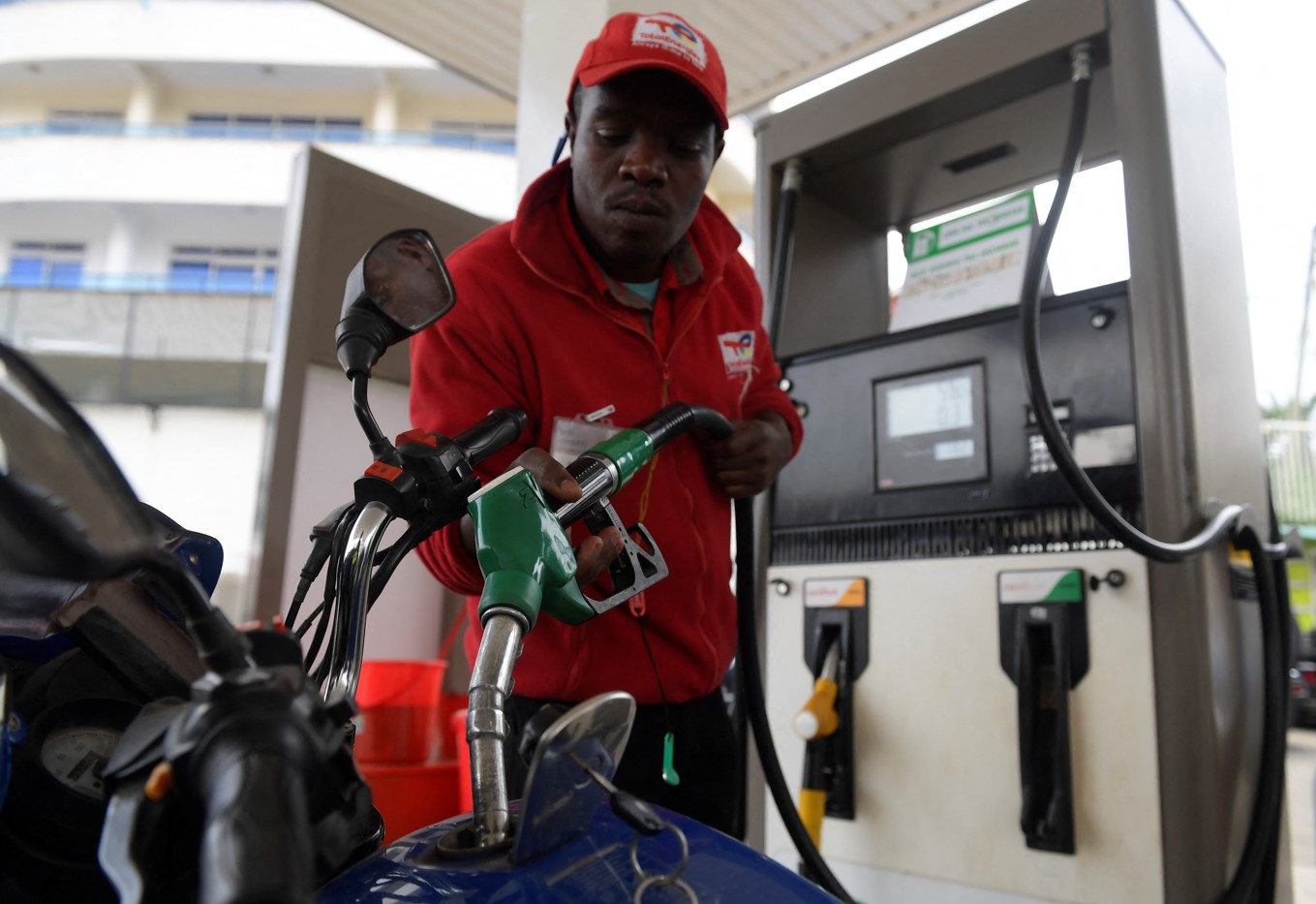 Motorists brace for higher fuel prices as Epra raises oil marketers’ margins - A worker fills the tank of a motorcycle at a petrol station in Nairobi on May 17, 2023. (Photo: Simon Maina/AFP)