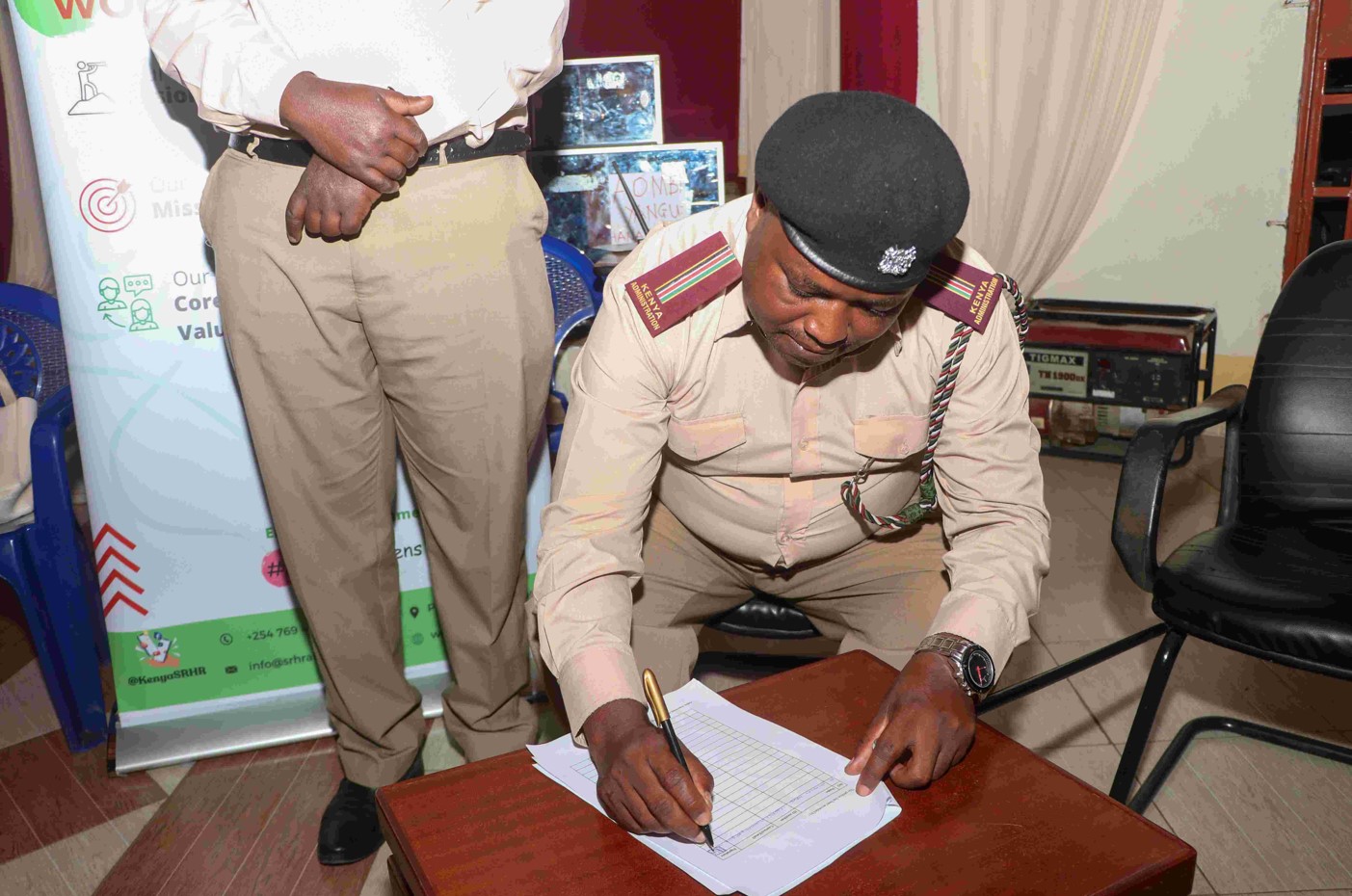 Airbase location chief Nicholas Maingi signs a petition presented to him on Comprehensive Sexuality Education and reproductive health education on youths durig a sensitisation event held at Penuel Education Complex in Kamukunji, Nairobi on April 22 2024. (Photo: Justine Ondieki) 
