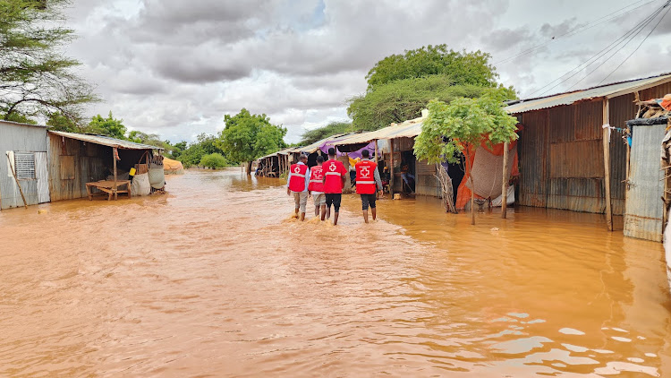 Red Cross workers wade through floods in North Eastern Kenya in September 2023. (Photo: Handout)