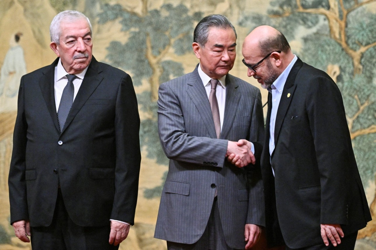 Mahmoud al-Aloul, Vice Chairman of the Central Committee of Palestinian organisation and political party Fatah, China's Foreign Minister Wang Yi, and Mussa Abu Marzuk, senior member of the Palestinian Islamist movement Hamas, attend an event at the Diaoyutai State Guesthouse in Beijing on July 23, 2024. (Photo: PEDRO PARDO/Pool via REUTERS)