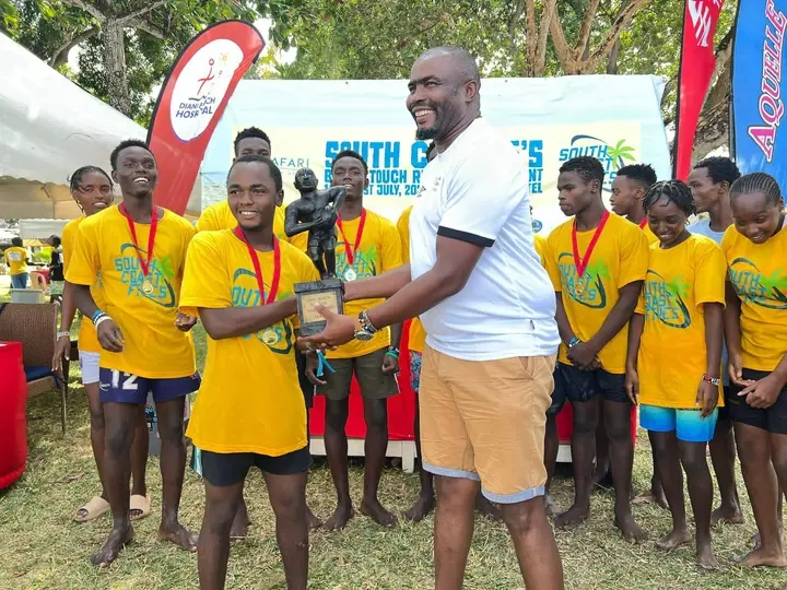 Likoni Community Rugby team receives a trophy from Kenya Rugby Union Vice Chairman Moses Ndale at Safari Beach Hotel in Diani after they were crowned The 2024 South Coast Fives winners on Sunday, July 21, 2024. (Photo: Mishi Gongo)