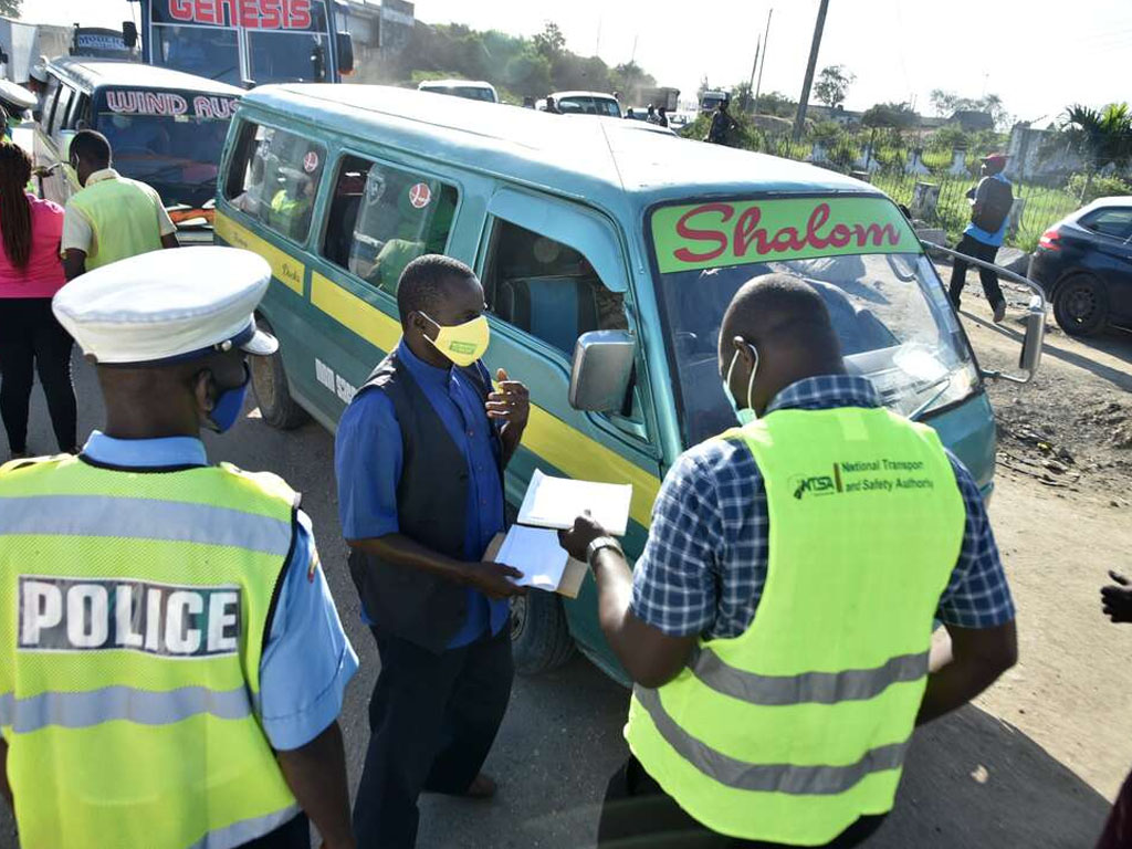 NTSA urges early vehicle inspections to avoid delays at checkpoints - An NTSA officer checks the documents of a matatu driver on a Kenyan road. (Photo: Handout)