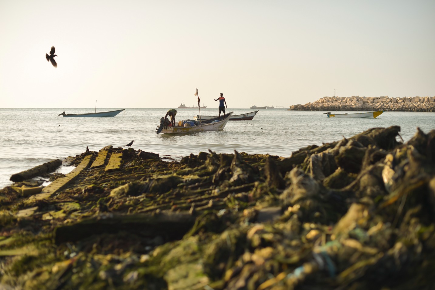 Two fishermen prepare their boat for a night of fishing at a port in Bossaso, Puntland. (Photo: UN)