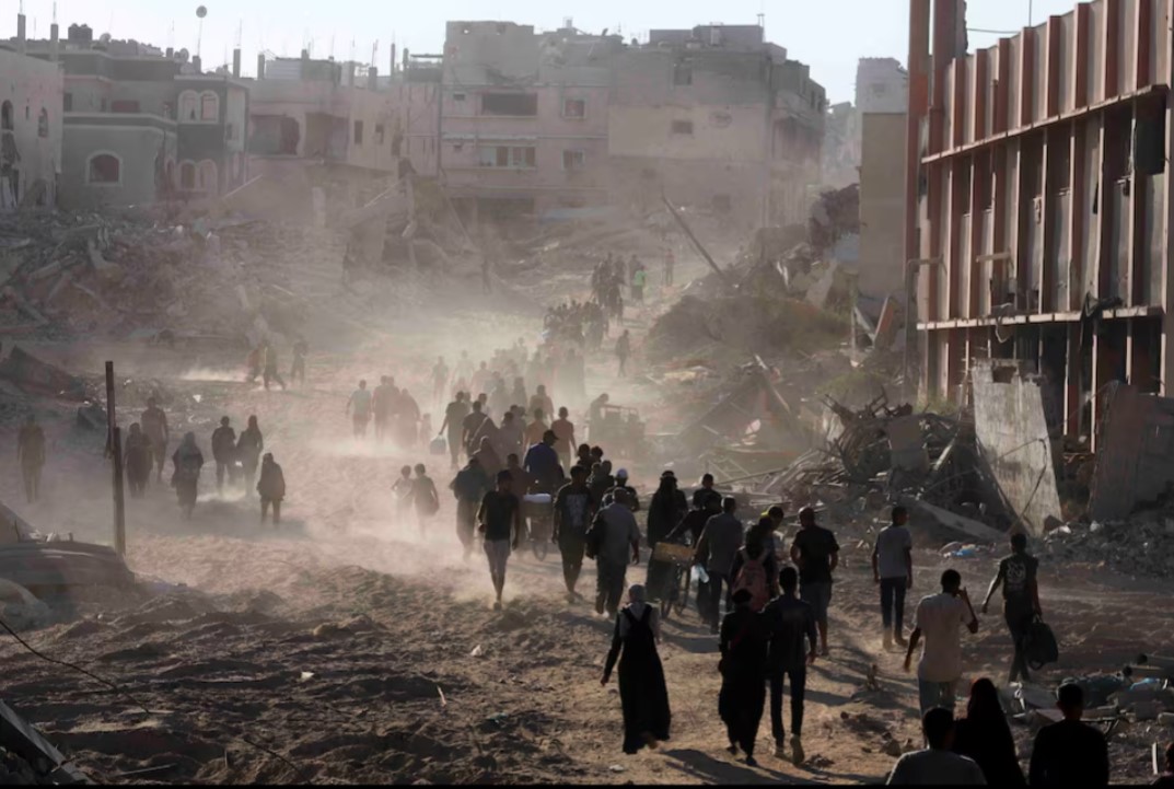 No propaganda on earth can hide the wound that is Palestine: Arundhati Roy - Palestinians make their way as they return to the eastern side of Khan Younis after Israeli forces pulled out from the area following a raid, amid the Israel-Hamas conflict, in Khan Younis, in the southern Gaza Strip July 30, 2024. (Photo: REUTERS/Hatem Khaled)