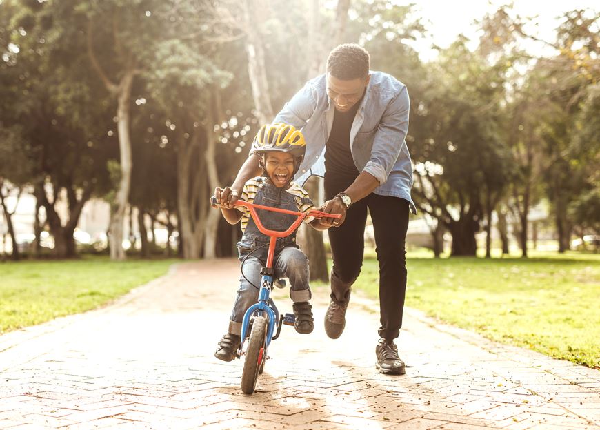 How parents' lifestyle choices shape their children's health and growth - A father teaching his son how to ride a bicycle. (Photo: Shutterstock)