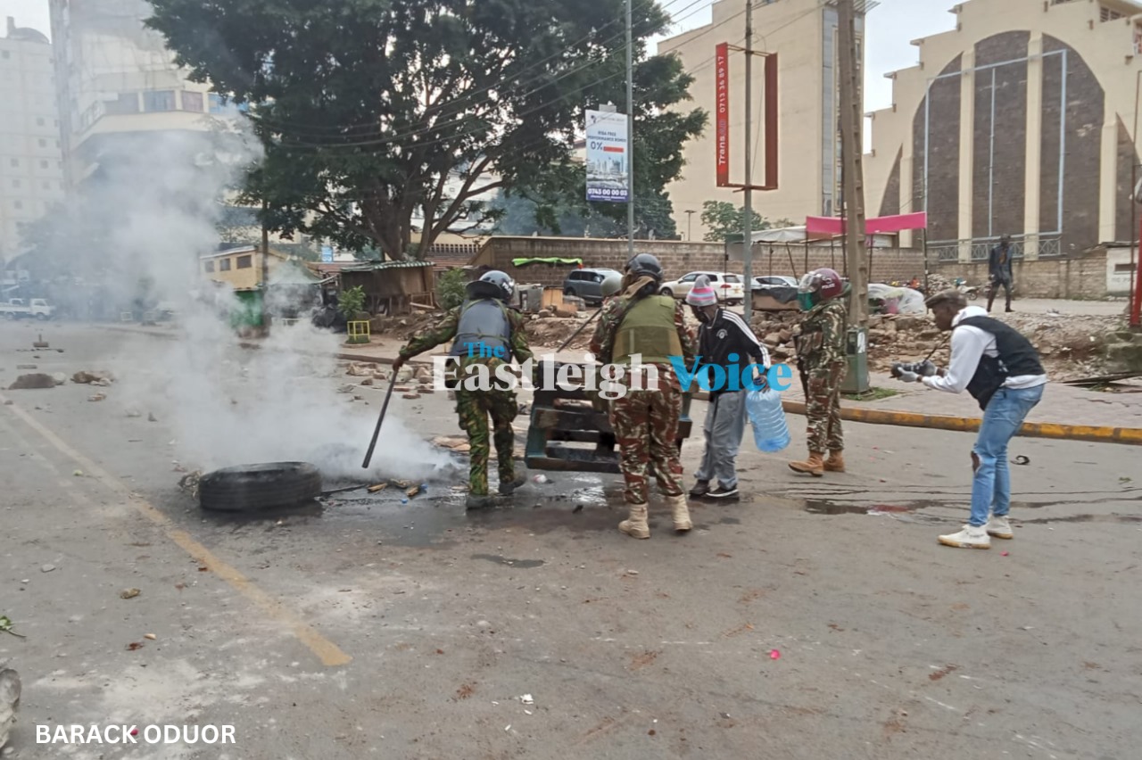 Police officers clear debris erected by protesters along Koinange Street in Nairobi. (Photo: Barack Oduor)