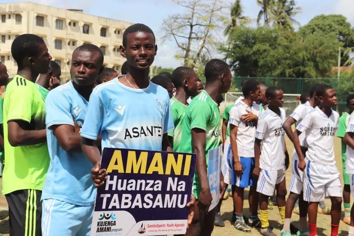 How Kwale's football tournament is shaping peaceful communities - Some of the teams from Kwale and Mombasa counties participating in a friendly tournament at Frere Town grounds in Mombasa.The youth are displaying placards with peace messages (C) Mishi Gongo 