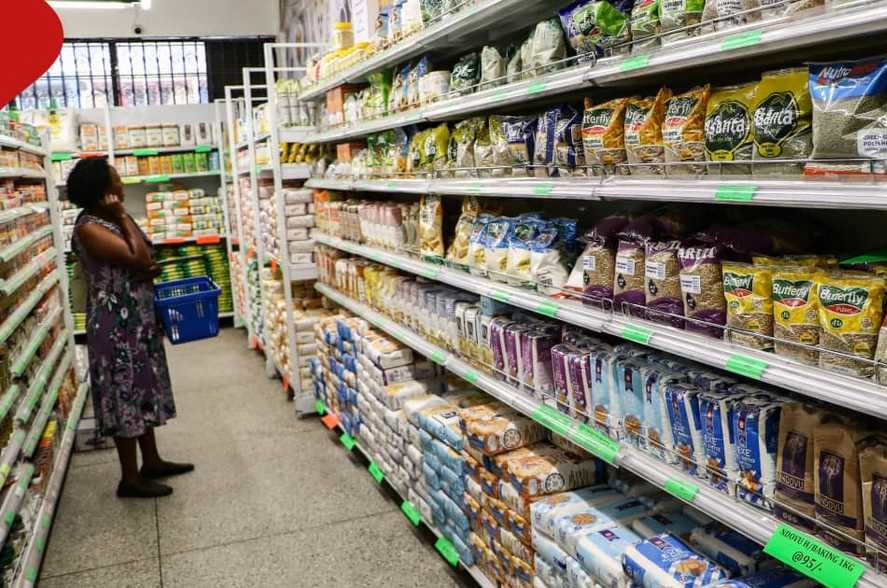 Kenyans express mixed views on state of economy as year nears close - A woman looks at the prices of commodities inside a supermarket. (Photo: Handout)