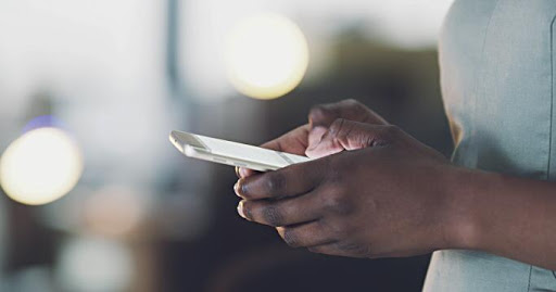 A customer using a phone for money transaction. (Photo: Handout)