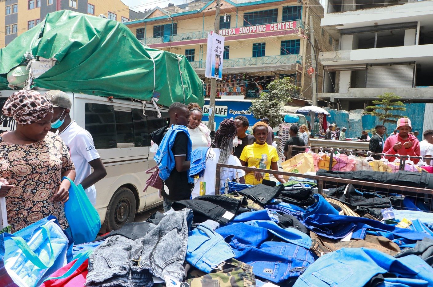 Major malls and affordable goods lure crowds to Eastleigh - A trader sells garments to customers on Jam Street in Eastleigh on August 28. Photo by Justine Ondieki. 
