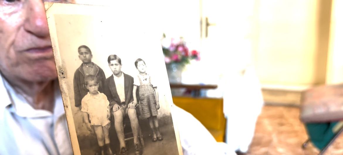 Mahmoud Al-Said holds a picture taken in 1951 of himself with his brothers.