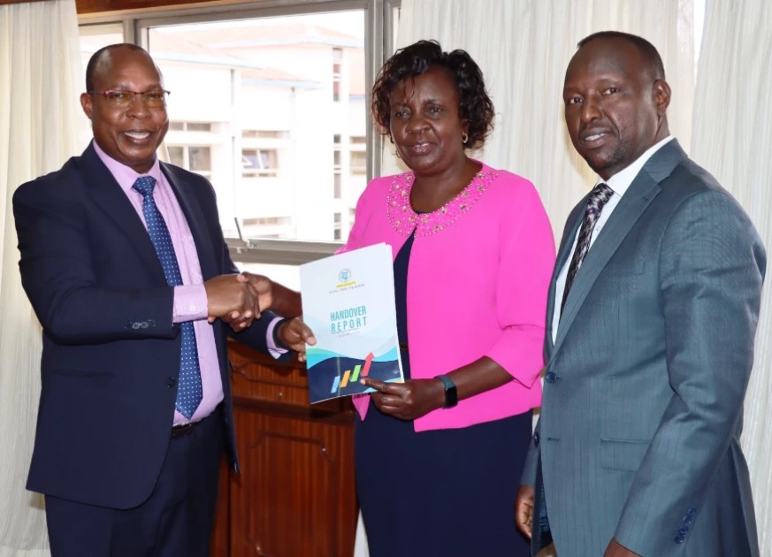 Education CS Ogamba in fresh efforts to bring order at Kenya Literature Bureau - Victor Lomaria (Right) handing over to Julius Aritho (Left) who takes over the leadership of KLB as Acting Managing Director. The Board Chair, Rispah Wepukhulu (Centre) oversaw the process./ Photo :KLB