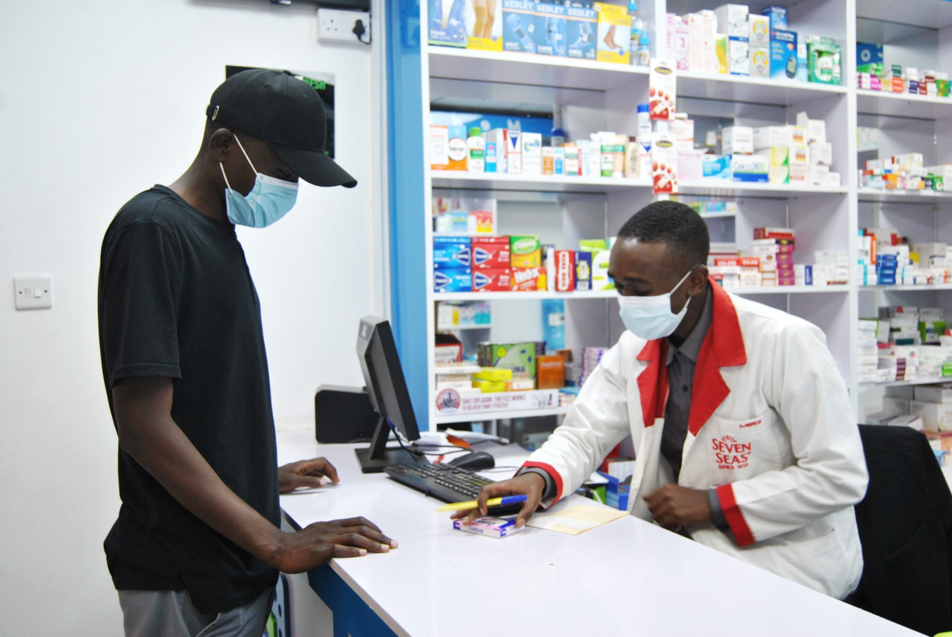 Health facilities in petrol stations, homes given six months to move or face closure - A patient buys medicine over the counter at a chemist in Nairobi. (Photo: Handout)