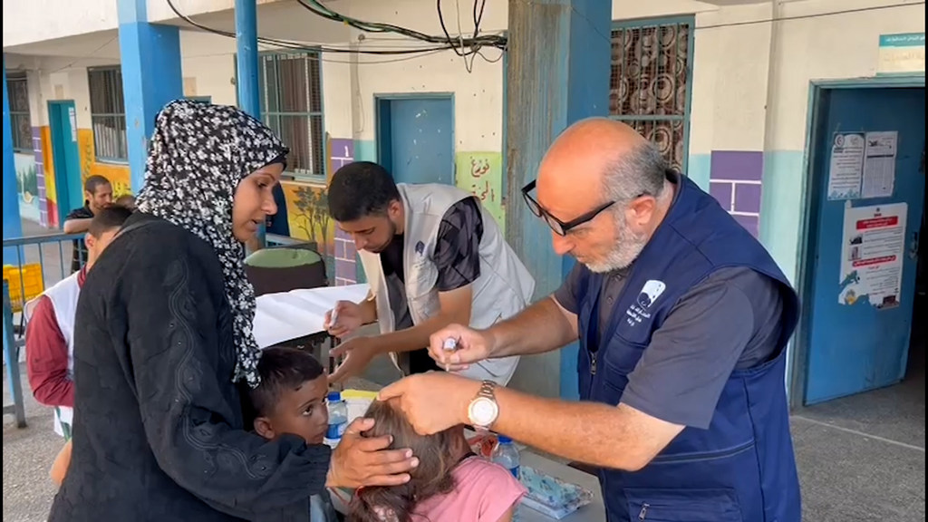 Om Samir, a mother, from Gaza City, with her children in an UNRWA school where the polio vaccination campaign is being conducted. (Photo: UN News)