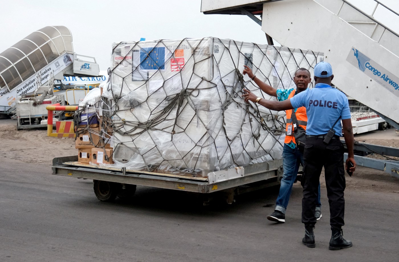 A security agent talks with a worker as he prepares to transport mpox vaccines as first batches arrive at N'Djili International Airport in Kinshasa, Democratic Republic of Congo September 5, 2024. ((Photo: REUTERS/Justin Makangara)