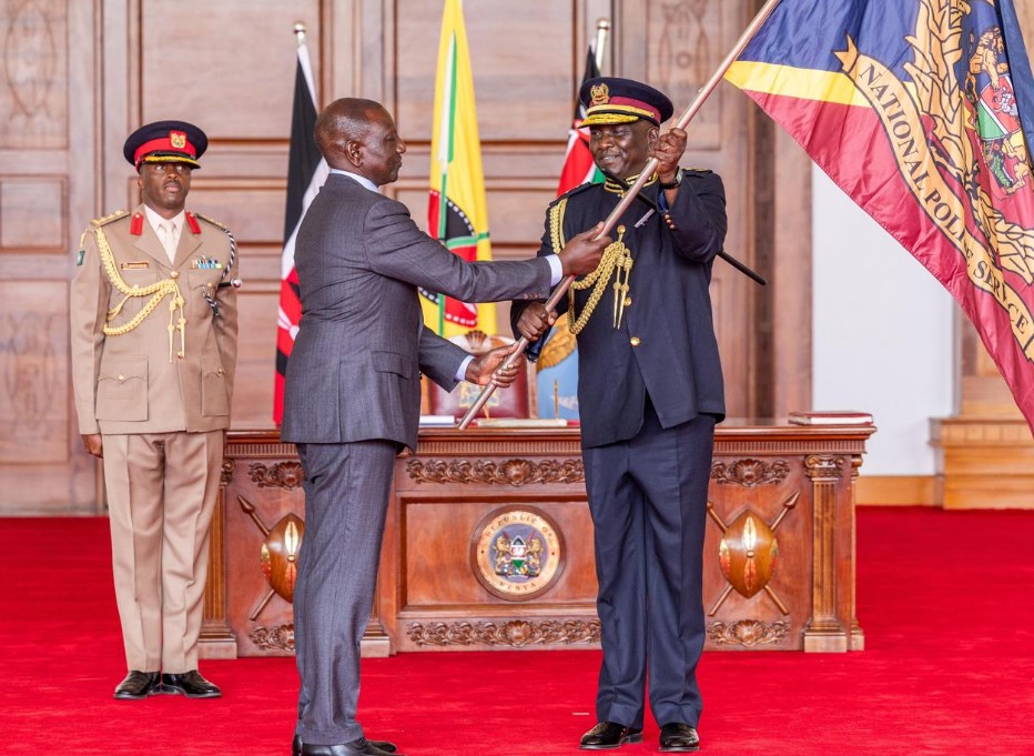 Ruto directs new police IG Douglas Kanja to shield NPS from manipulation - President William Ruto hands over the National Police Service flag to the new Inspector General of Police Douglas Kanja on September 19, 2024. (Photo: Handout)