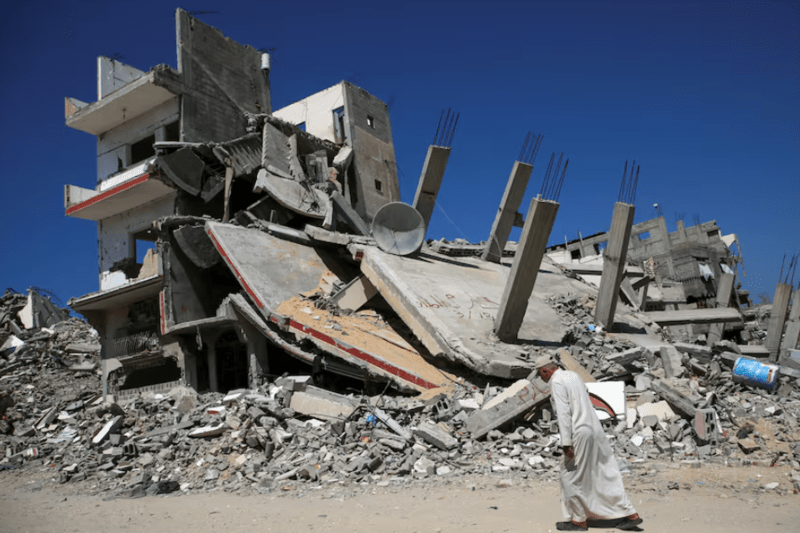 CIA, Mossad chiefs to meet Qatar PM for Gaza ceasefire, hostage talks, official says - A Palestinian man walks past the rubble of a house destroyed in the Israel's military offensive, amid the Israel-Hamas conflict, in Khan Younis, in the southern Gaza Strip, September 26, 2024. (Reuters)