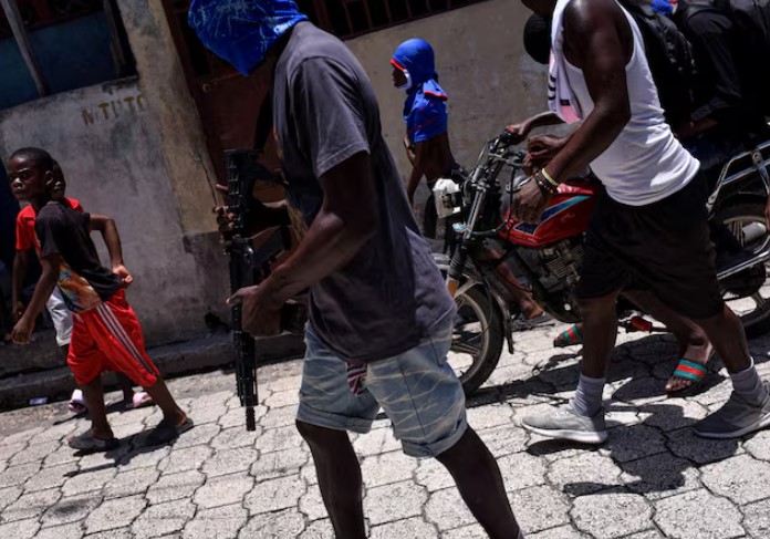 US issues travel advisory on Haiti following rising gang violence cases - Children accompany armed gang members in a march organised by former police officer Jimmy "Barbecue" Cherizier, leader of an alliance of armed groups, in the Delmas neighbourhood, in Port-au-Prince, Haiti, May 10, 2024. (Photo: /REUTERS/Pedro Valtierra Anza)