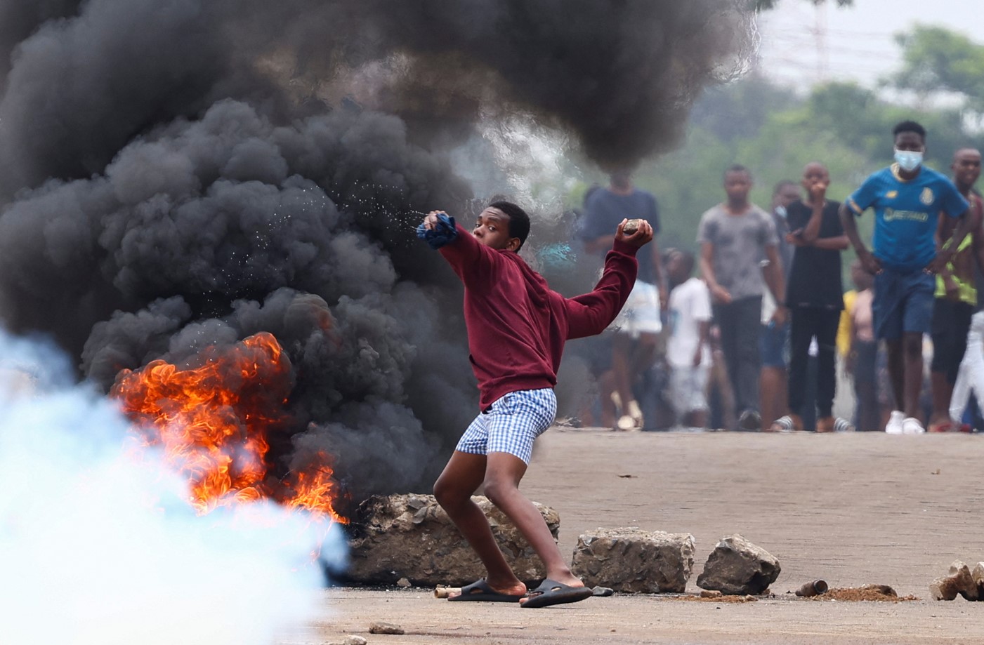 A protester throws a stone during a nationwide strike called by Mozambique presidential candidate Venancio Mondlane to protest the provisional results of an October 9 election in Maputo, Mozambique, on October 21, 2024. (Photo: REUTERS/Siphiwe Sibeko)