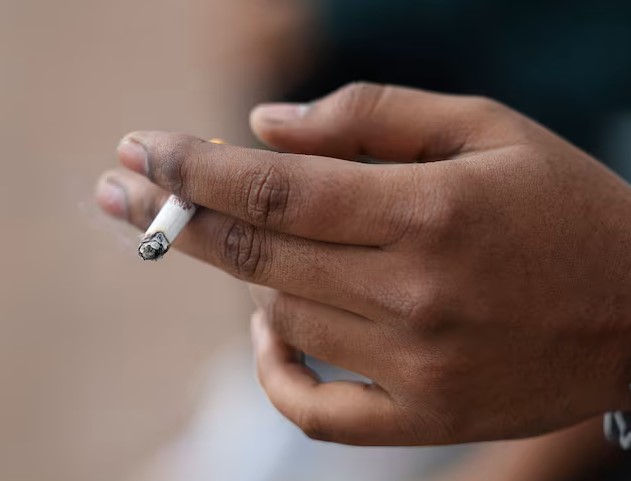 Smokers have a higher level of harmful bacteria in the mouth – new study - A man holds his cigarette as he smokes in London, Britain, April 11, 2024. Photo: REUTERS/Isabel Infantes)