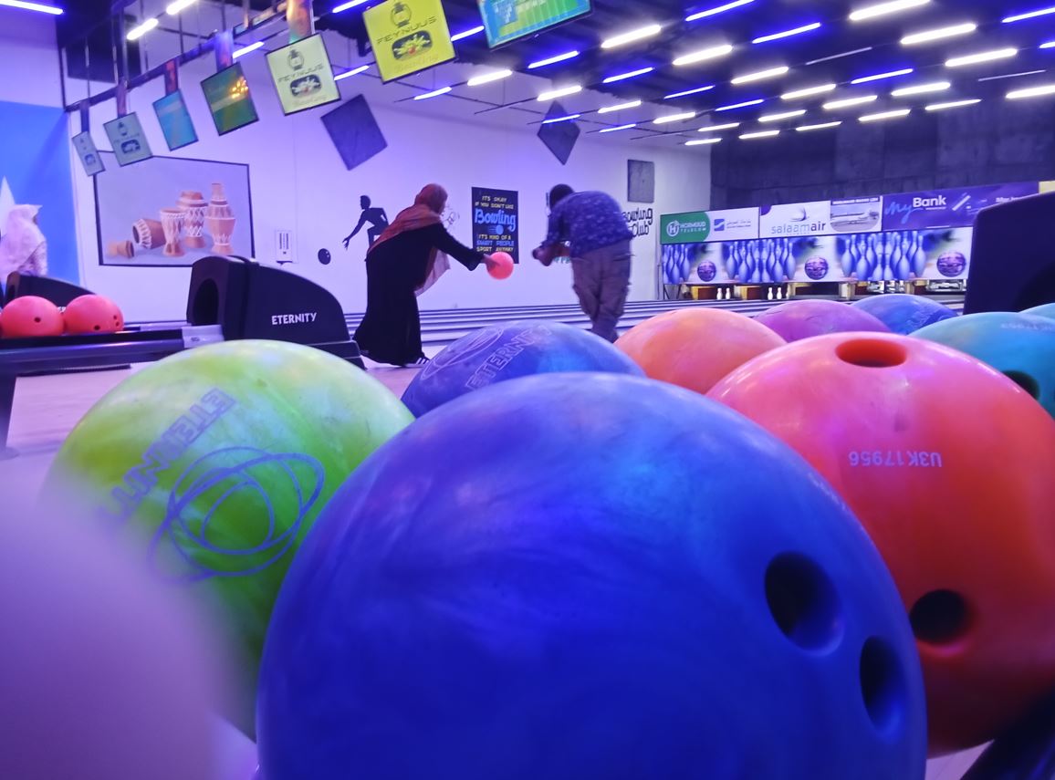 A view of the brightly lit bowling lanes at Feynuus, where multiple screens display scores, creating a lively atmosphere in central Mogadishu. (Photo: Hassan Mohamed)