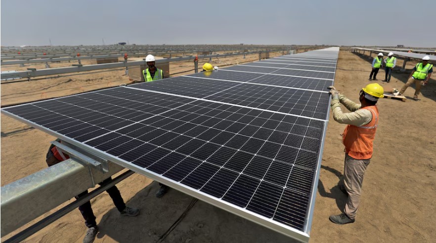 Adani bribery allegations shine spotlight on India's clean energy puzzle - Workers install solar panels at the Khavda Renewable Energy Park of Adani Green Energy Ltd in Khavda, India on April 12, 2024. (Photo: File/REUTERS/Amit Dave)