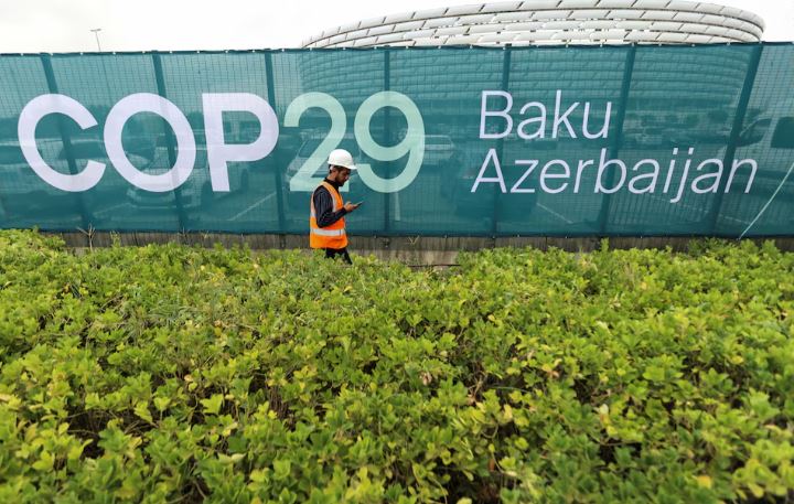 What to expect from COP29 climate talks in Baku, Azerbaijan - A worker walks along a fence near the Baku Olympic Stadium, the venue of the COP29 United Nations Climate Change Conference, in Baku, Azerbaijan October 18, 2024. (Photo: REUTERS/Aziz Karimov)