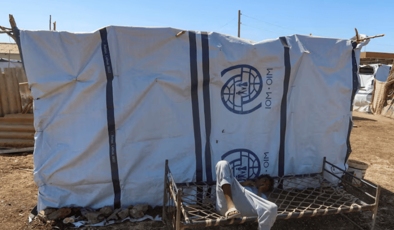 US imposes sanctions on Sudanese paramilitary commander - A boy displaced from Sudan's Gezira state due to Rapid Support Forces violence, lies down on a bench with the logo of the International Organization for Migration in New Halfa, Sudan, November 2, 2024. (Reuters)