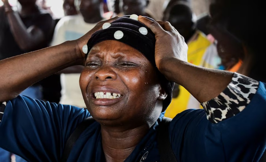 Death toll in Uganda landslide rises to 17, dozens of homes buried - A woman reacts as she looks at bodies of her relatives killed in a landslide triggered by heavy rain that buried dozens of homes across several villages in Bulambuli district, Uganda. (Photo: REUTERS/Abubaker Lubowa)