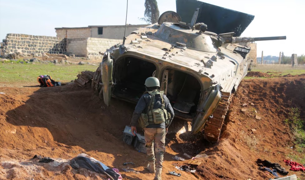 With world distracted by conflicts elsewhere, Syrian civil war flares up again - A rebel fighter walks near a military vehicle in Menagh, north of Aleppo, Syria December 2, 2024. (Photo: REUTERS/Mahmoud Hassano)