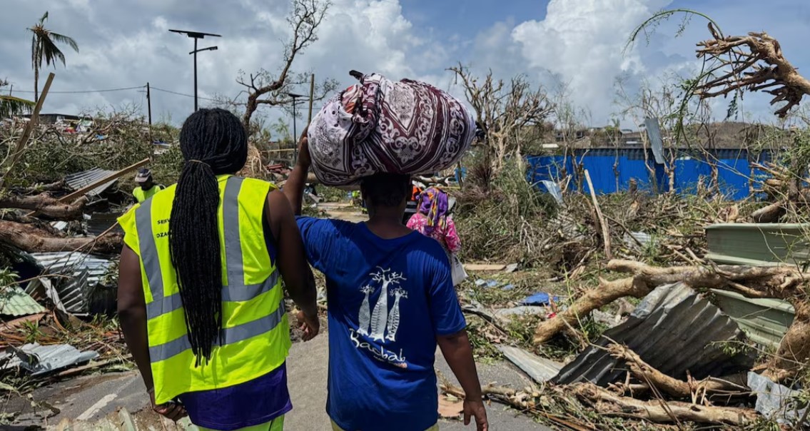 Mayotte cyclone kills several hundred, maybe thousands, in worst storm in century - People walk amid debris in Labattoir, Mayotte on December 15, 2024 after Cyclone Chido swept through the French archipelago. (Photo: REUTERS/Chafion Madi)