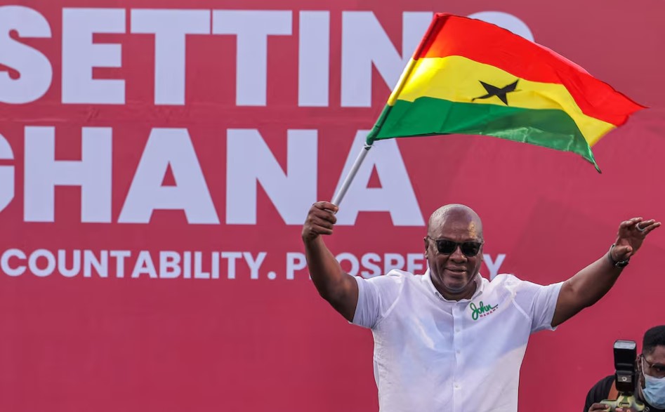 Ghana's former president John Dramani Mahama's comeback sparks hope for future - Former Ghanaian president John Dramani Mahama holds the country’s flag as he waves to supporters during his final election campaign rally in Accra on December 5, 2024. (Photo: File/REUTERS/Zohra Bensemra)