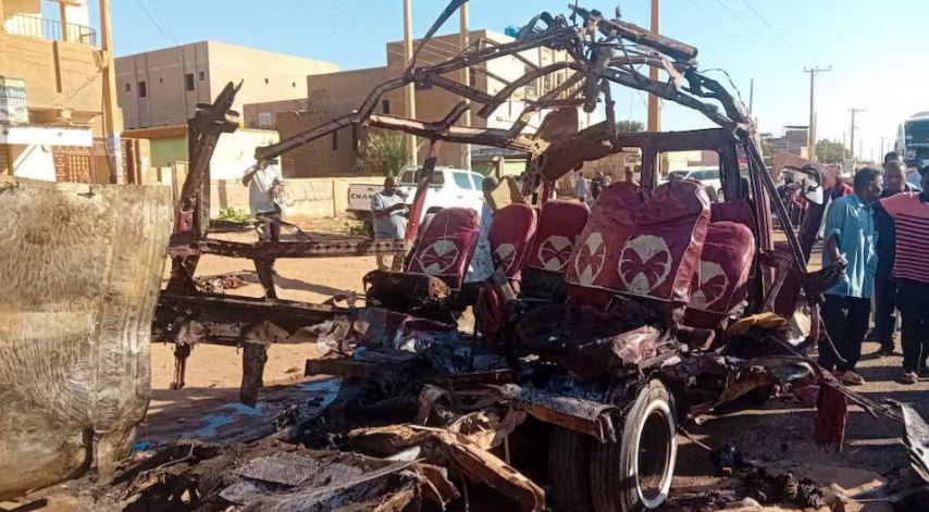 RSF attacks main hospital in Sudan's al-Fashir, says health official - People gather near a destroyed vehicle following shelling by the Rapid Support Forces in Omdurman, Sudan on December 10, 2024. (Photo: Khartoum State Government/Handout via REUTERS)