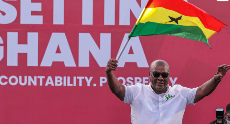 Ghana's ex-President Mahama wins election, ruling party candidate concedes defeat - National Democratic Congress (NDC) presidential candidate and former Ghanaian President John Dramani Mahama holds a national flag as he waves to supporters during his final election campaign rally in Accra, Ghana December 5, 2024. REUTERS