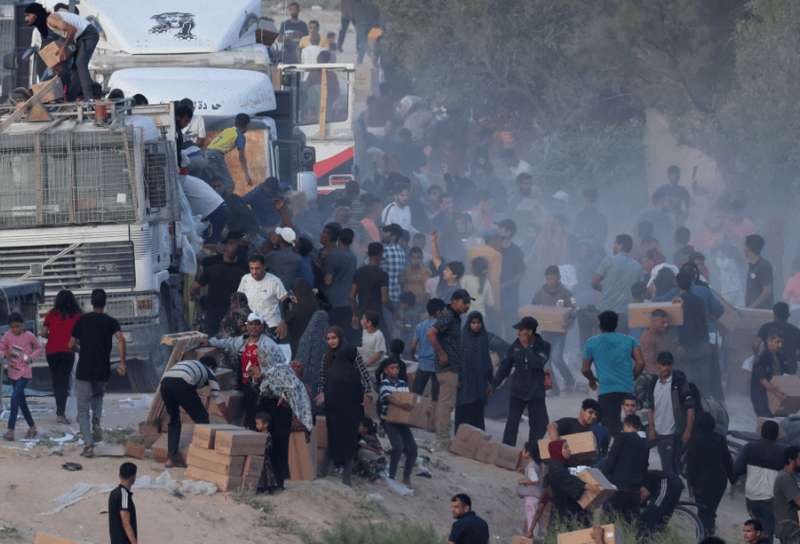 Israel, Hamas reach ceasefire agreement - Palestinians climb onto trucks to grab aid delivered into Gaza through a U.S.-built pier in May, 2024. (Photo: REUTERS/Ramadan Abed)