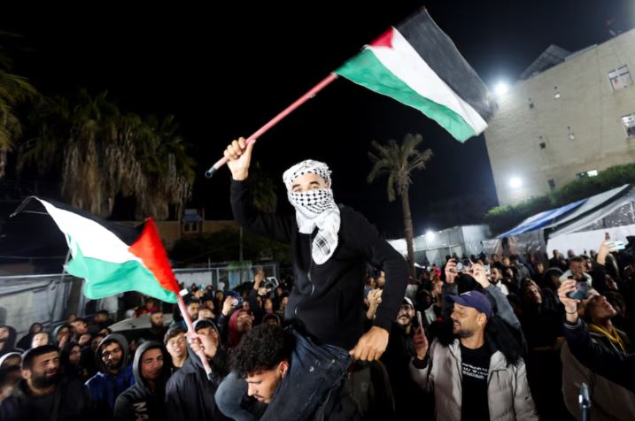 AU backs Gaza ceasefire, urges full implementation of pact - A man waves Palestinian flags as Palestinians react to news on a ceasefire deal with Israel, in Deir Al-Balah in the central Gaza Strip, January 15, 2025. (Photo: REUTERS/Ramadan Abed)