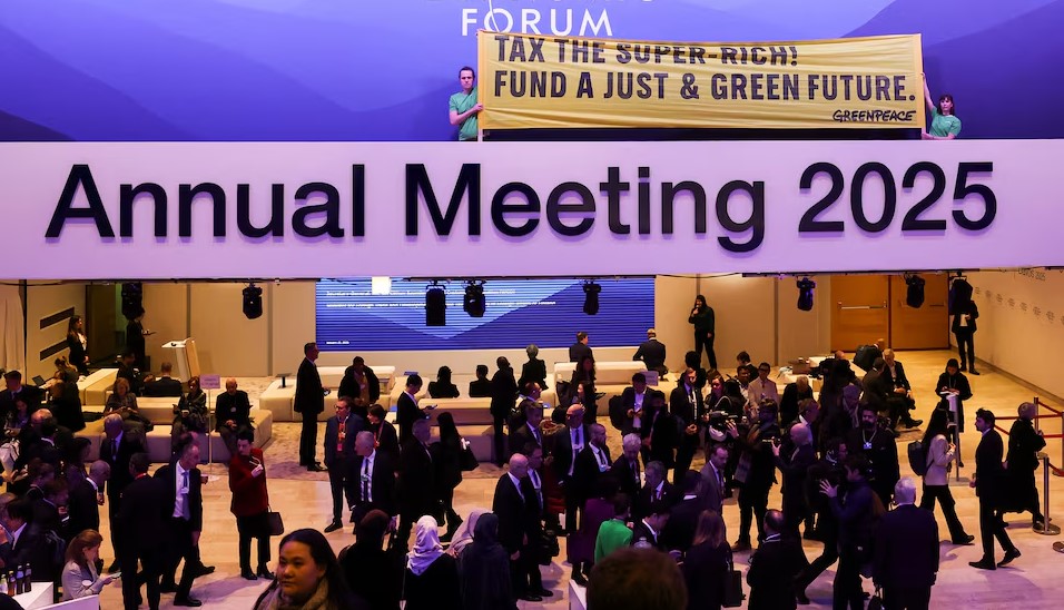 African Climate Group slams US withdrawal from Paris Agreement, calls for continued multilateral efforts - Greenpeace activists hold a banner as they protest in the Congress Centre during the 55th annual World Economic Forum meeting in Davos, Switzerland on January 21, 2025. Trump’s withdrawal from the Paris Agreement has been met with disappointment. (Photo: REUTERS/Yves Herman)