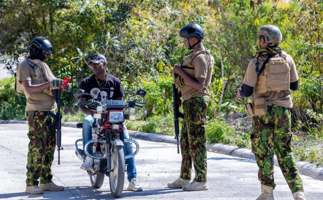 US freezes over Sh1.7 billion funding for Kenya-led Haiti security mission - Some of the Kenyan police officers serving in Haiti inspecting the documents of a motorbike rider. (Photo: NPS)