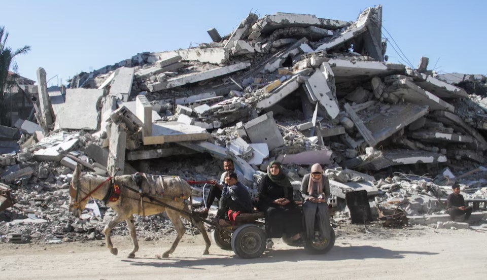 Gaza ceasefire deal between Israel and Hamas takes effect as fighting halts after 3-hour delay - Palestinians ride a donkey cart past the rubble in Gaza City on January 19, 2025, before a ceasefire between Israel and Hamas took effect. (Photo: REUTERS/Mahmoud Issa)