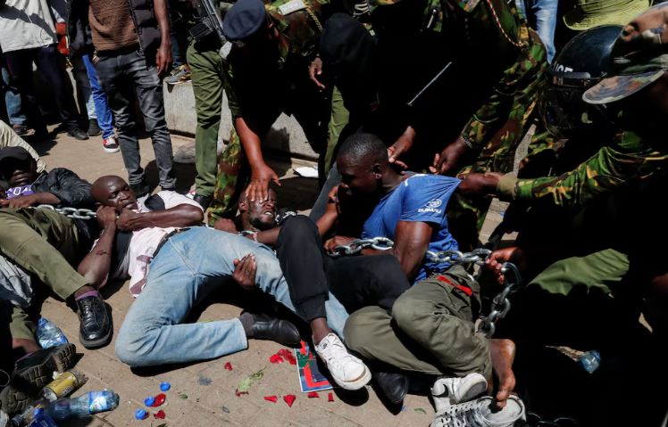 How Kenya police hid killings of anti-government protesters - Riot police officers detain protesters demonstrating against what they say is a wave of unexplained abductions of government critics, along the Aga Khan walk in downtown Nairobi, Kenya December 30, 2024. (Photo: REUTERS/Thomas Mukoya)