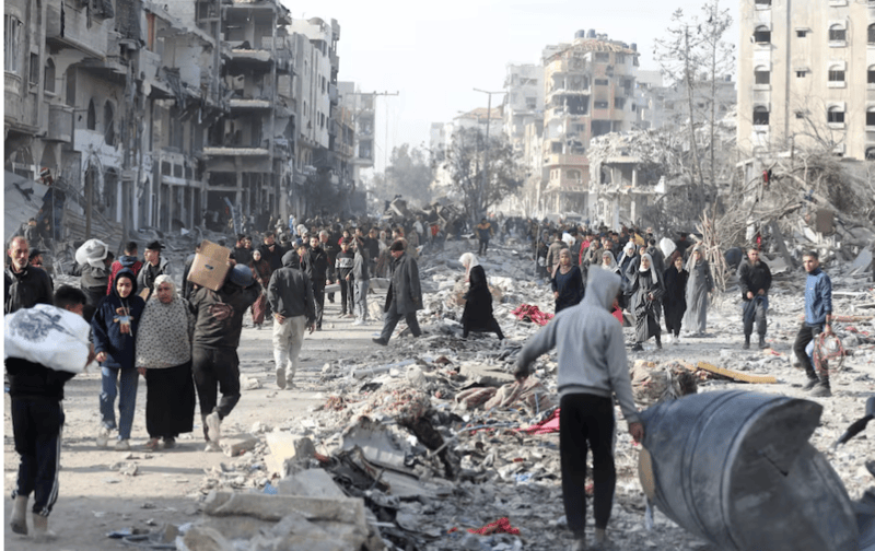 US pushes Gaza relocation plan in high-stakes Cairo meetings - Displaced Palestinians walk past the rubble as they attempt to return to their homes, following a delay in the ceasefire between Israel and Hamas over the hostage list, in the northern Gaza Strip, January 19, 2025. REUTERS