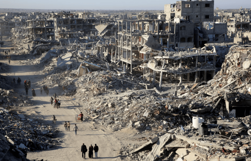 In pictures: Gaza in ruins as residents return home - Palestinians walk past the rubble of houses and buildings destroyed during the war, following a ceasefire between Israel and Hamas, in Rafah in the southern Gaza Strip, January 20. REUTERS/Hatem Khaled