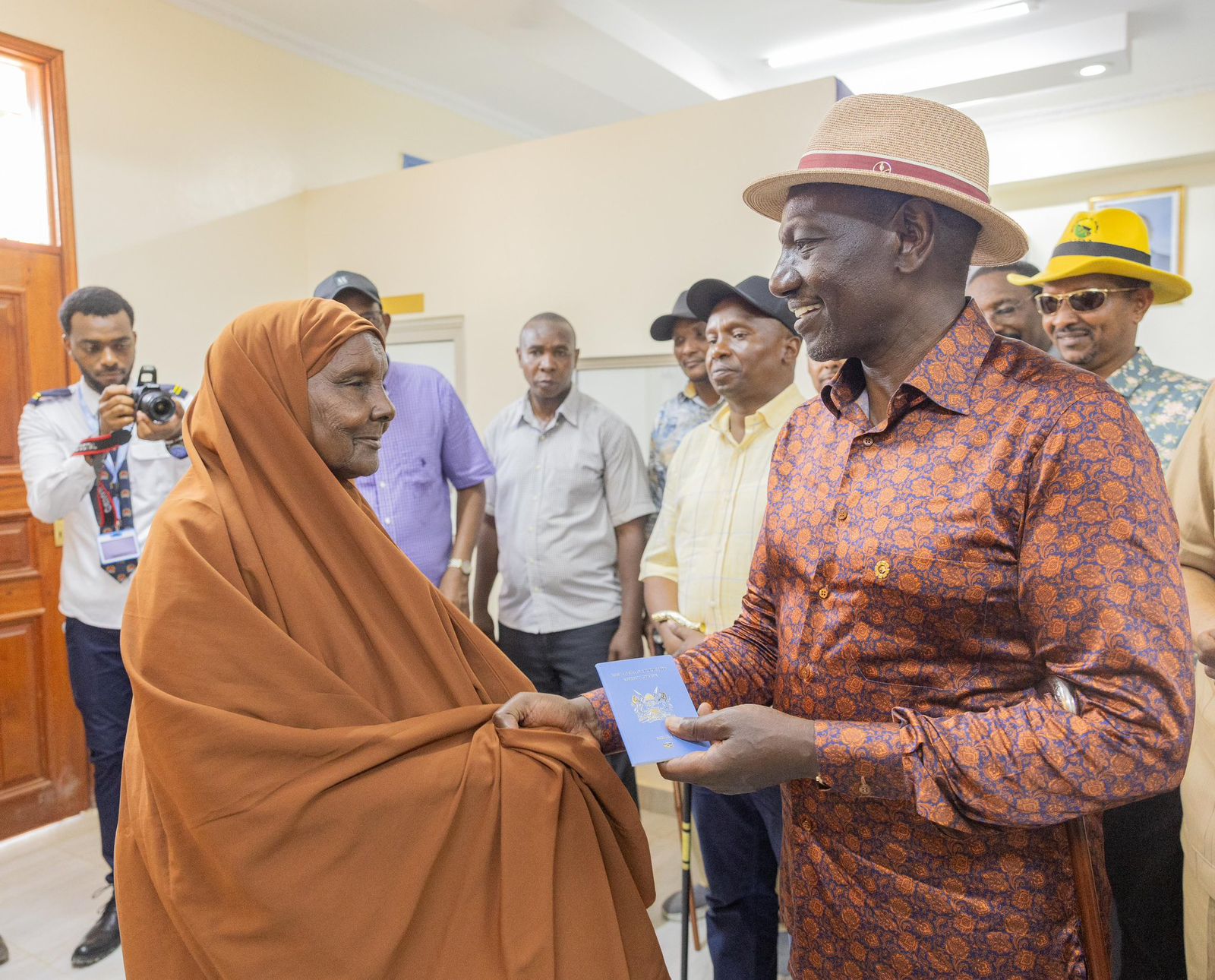 Ruto orders removal of green channel as Garissa passport office re-opens - President William Ruto handing over a passport to a Garissa resident following the re-opening of the  Garissa passport centre on February 6, 2025. (PCS)