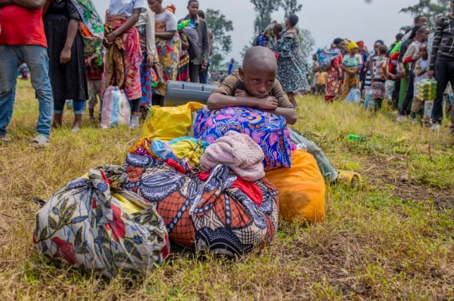 DRC takes Rwanda to African Court of Human Rights over deadly conflict - People who crossed from Congo wait for assistance in Gyseny, Rwanda, on Tuesday, following M23 rebels' advances into eastern Congo's capital Goma. (Photo: Yuhi Irakiza/AP)