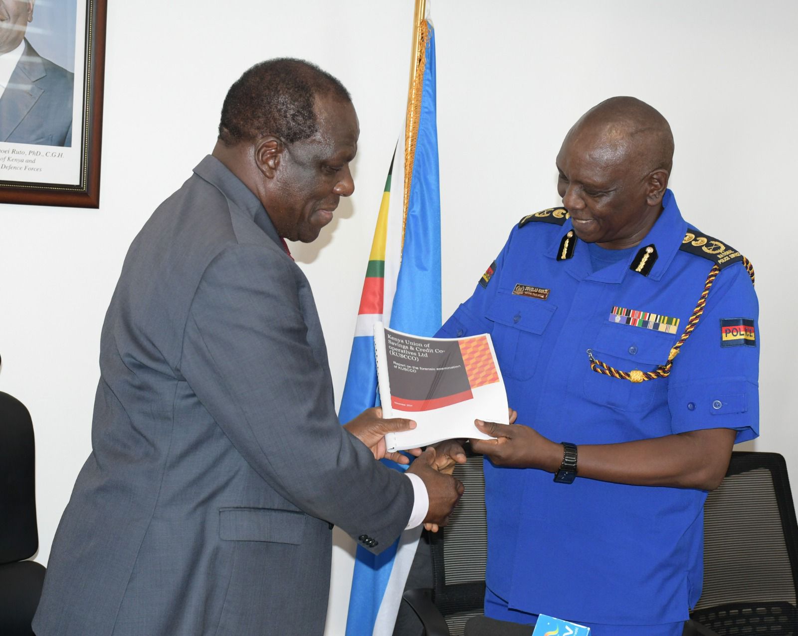 Police arrest four suspects as probe into KUSCCO scandal begin - Cooperatives CS Oparanya handing over the KUSCCO Forensic Audit Report to IG Douglas Kanja.